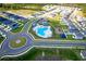 Aerial view of community pool, playground, and common area surrounded by modern homes and lush landscaping at 214 Brave Rd, Davenport, FL 33837