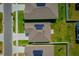 A high aerial view shows symmetrical homes with solar panels and well-manicured lawns in a neat neighborhood at 214 Brave Rd, Davenport, FL 33837