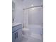 Well-lit bathroom with a bathtub-shower combo and gray cabinets at 214 Brave Rd, Davenport, FL 33837