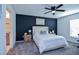 Cozy bedroom featuring a dark accent wall, neutral decor, and a comfortable bed, creating a relaxing retreat at 214 Brave Rd, Davenport, FL 33837