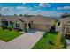 Inviting home with a lush green lawn, an attached garage, and attractive landscaping, offering great curb appeal at 214 Brave Rd, Davenport, FL 33837