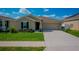 Charming single-Gathering home with a well-maintained lawn, an attached two-car garage, and manicured landscaping at 214 Brave Rd, Davenport, FL 33837