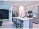 Contemporary kitchen featuring stainless steel appliances, a center island with seating, and sleek countertops at 214 Brave Rd, Davenport, FL 33837