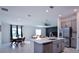Bright and airy open floor plan showcasing a modern kitchen with an island, a dining area, and a cozy living space at 214 Brave Rd, Davenport, FL 33837