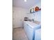 This compact laundry room has a washer, dryer, shelving, and tiled floors at 214 Brave Rd, Davenport, FL 33837