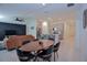 Open-concept living space featuring a modern kitchen with an island, dining area, and a cozy living room with a stylish accent wall at 214 Brave Rd, Davenport, FL 33837