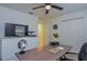 This well-lit office has neutral walls, a ceiling fan and carpeted floors at 214 Brave Rd, Davenport, FL 33837