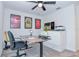 This office is well-lit and decorated with sports memorabilia and a ceiling fan at 214 Brave Rd, Davenport, FL 33837