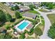 Aerial view shows the community pool with lounge area and well-maintained landscaping at 214 Glasgow Ct, Davenport, FL 33897