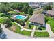 Overhead shot of a community pool with inviting lounge chairs and lush landscaping at 214 Glasgow Ct, Davenport, FL 33897