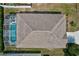 Aerial view showcases a screen-enclosed pool with crystal-clear water at 214 Glasgow Ct, Davenport, FL 33897