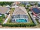 Aerial view of a home with a screened-in pool and well-maintained backyard at 214 Glasgow Ct, Davenport, FL 33897