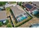 Aerial view of a home with a screened-in pool and neatly landscaped yard at 214 Glasgow Ct, Davenport, FL 33897