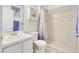 Clean bathroom with tiled shower, white vanity, and neutral color palette at 214 Glasgow Ct, Davenport, FL 33897