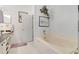Bright bathroom featuring a soaking tub, tiled floors, and sink vanity at 214 Glasgow Ct, Davenport, FL 33897