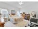 Spacious bedroom with ceiling fan, floral bedding, and desk setup perfect for relaxing at 214 Glasgow Ct, Davenport, FL 33897