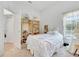 Well-lit bedroom with single bed, wooden bookshelves, and large window with sunny view at 214 Glasgow Ct, Davenport, FL 33897