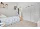 Bright bedroom featuring a single bed with comfortable blue patterned bedding, shelving, and closet at 214 Glasgow Ct, Davenport, FL 33897