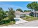 Charming single-story home featuring a well-manicured lawn and attached two-car garage at 214 Glasgow Ct, Davenport, FL 33897