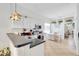 Well-maintained kitchen with black counters, white cabinets, and an adjacent breakfast nook at 214 Glasgow Ct, Davenport, FL 33897