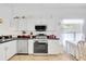 Functional kitchen with modern appliances, ample counter space, and white cabinetry at 214 Glasgow Ct, Davenport, FL 33897