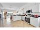 Efficient kitchen with modern appliances and adjacent cozy living area in neutral colors at 214 Glasgow Ct, Davenport, FL 33897