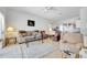 Spacious living room open to kitchen features neutral tones and lots of natural light at 214 Glasgow Ct, Davenport, FL 33897