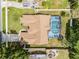 Aerial view of a home with a screened-in pool, a well-manicured lawn, and a driveway at 2203 Essex Dr, Ocoee, FL 34761