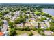 Aerial view of a home in a residential neighborhood, featuring mature trees and well-maintained landscaping at 2203 Essex Dr, Ocoee, FL 34761