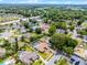 Aerial view of a property outlined in red, featuring a pool and surrounded by lush greenery at 2203 Essex Dr, Ocoee, FL 34761
