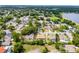 Neighborhood aerial view with tree-lined streets, a lake, and various home styles at 2203 Essex Dr, Ocoee, FL 34761