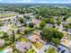 Aerial view of a property outlined in red, featuring a pool and surrounded by lush greenery at 2203 Essex Dr, Ocoee, FL 34761