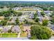 Aerial view of a home outlined in red, with a backyard pool, in a neighborhood with mature trees at 2203 Essex Dr, Ocoee, FL 34761