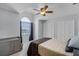 Bedroom with a ceiling fan, window, and two closets, providing plenty of space and natural light at 2203 Essex Dr, Ocoee, FL 34761