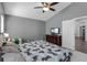 Bedroom with a ceiling fan, TV, and access to another room through a door at 2203 Essex Dr, Ocoee, FL 34761