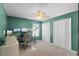 This bedroom features a ceiling fan, two closets and a desk with a triple monitor setup at 2203 Essex Dr, Ocoee, FL 34761