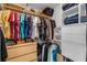 Well-organized walk-in closet with hanging clothes, shelves, and drawers for ample storage at 2203 Essex Dr, Ocoee, FL 34761