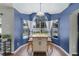 Bright dining area features natural light, an island, and outdoor views of the pool at 2203 Essex Dr, Ocoee, FL 34761