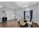 Formal dining area boasts wood floors, chandelier, and a view from the arched window and front door at 2203 Essex Dr, Ocoee, FL 34761