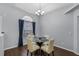 Formal dining area boasts wood floors, chandelier, and a view from the arched window at 2203 Essex Dr, Ocoee, FL 34761