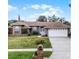 Charming single-story home featuring a well-maintained lawn, brick accents, and a two-car garage at 2203 Essex Dr, Ocoee, FL 34761