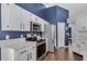 Kitchen featuring white cabinets, stainless steel appliances, and tile floors at 2203 Essex Dr, Ocoee, FL 34761