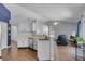 Open floor plan featuring updated kitchen with stainless steel appliances and breakfast bar at 2203 Essex Dr, Ocoee, FL 34761