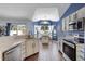 Kitchen with island and views of the backyard and pool through a large window at 2203 Essex Dr, Ocoee, FL 34761
