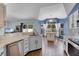Open kitchen features stainless steel appliances, island seating, and breakfast nook at 2203 Essex Dr, Ocoee, FL 34761