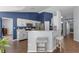 Eat-in kitchen area with breakfast bar and seating features wood floors and modern appliances at 2203 Essex Dr, Ocoee, FL 34761
