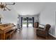Spacious living room with wood-look tile floors and sliding glass doors to the screened patio at 2203 Essex Dr, Ocoee, FL 34761