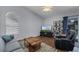 Comfortable living room with wood floors, lots of natural light, and adjacent to the kitchen at 2203 Essex Dr, Ocoee, FL 34761