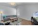 Comfortable living room with wood floors, lots of natural light and adjacent to the kitchen at 2203 Essex Dr, Ocoee, FL 34761