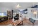 Spacious living room adjacent to kitchen with wood floors and ceiling fan at 2203 Essex Dr, Ocoee, FL 34761